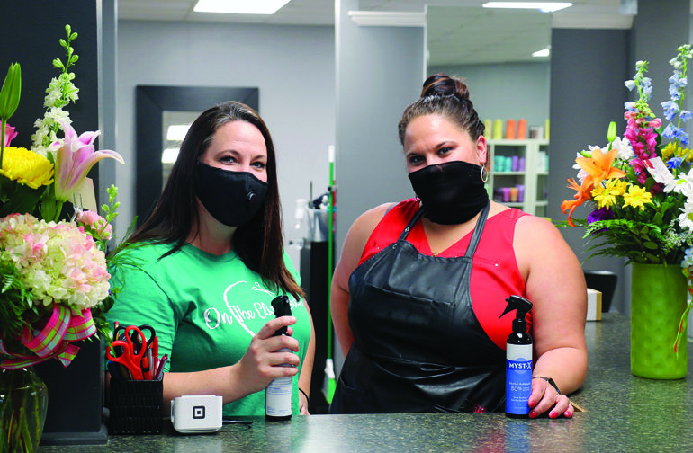 On the Clip Side is one of the many salons now opened and playing catch-up. Pictured are Jennifer Cox, left, and Megan Piper, right. Many stylists have been working extra long hours to recover all the time lost with regular clients. “Most that were on the cancellation lists have been seen or are on the books. It’s going pretty smooth,” said Cox. 