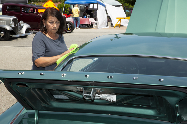Barb Wise, of Springfield, polishes up her 1969 Mustang E. She and her husband, Tim, refurbished the car after buying it six years ago, including switching from yellow to the original green. Only 96 of the E cars were made, to compete in the Mobilgas Economy Run that would take cars from coast to coast, to see which could deliver the best gas mileage.