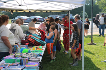 Attendees wait to sign in and choose backpacks at the recent First Baptist Church Back to School Bash.