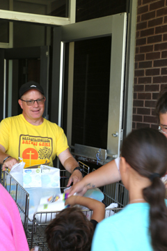 First Baptist Church Pastor Patrick Embley delivers items from The Pantry at the church’s Back to School Bash.