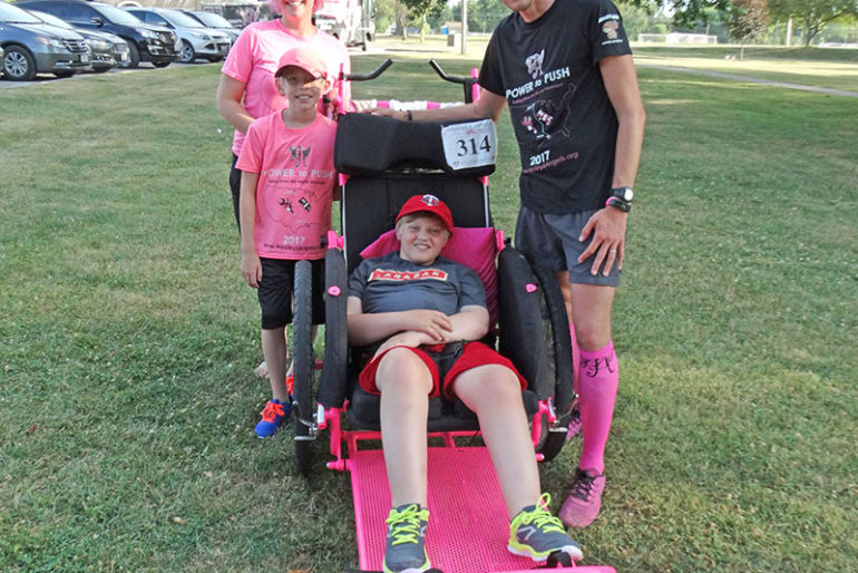 The Evans family from New York is running the length of the ‘Mighty Mississippi’ this summer in 29 days. Pictured left to right: mother, Nichole, and younger brother, Simon, who both provide support along the route; Shamus (in the large jogger chair) and Shaun, who run the entire way. The Evans family knows how receiving assistance from Ainsley