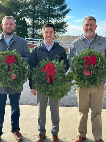 Airsman-Hires Directors, from left, Andrew Morgan, Ryan May and Danny Powell, hold wreaths that will adorn veterans’ graves.