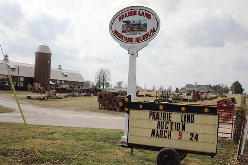 Signage on Prairie Land Heritage Museum grounds advertises for the upcoming consignment auction; the grounds are just a few days into the weeklong consignment drop-off period.