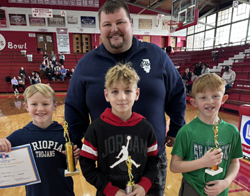 Ages 8-9 Boys division winners, from left: Owen Meyer – Triopia (1st place), Rowan Jefferson – Eisenhower (2nd place) and Grayson Frisch – Our Saviour (3rd place). Jacksonville Elks Lodge #682 President James Lomelino is in back.